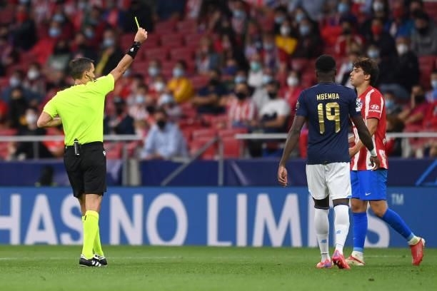 Matheus Cunha of Atletico Madrid is shown a yellow card from Referee Ovidiu Hategan during the UEFA Champions League group B match between Atletico...