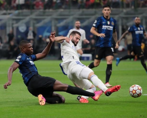 Denzel Dumfries of FC Internazionale is challenged by Nacho Fernández of Real Madrid during the UEFA Champions League group D match between Inter and...