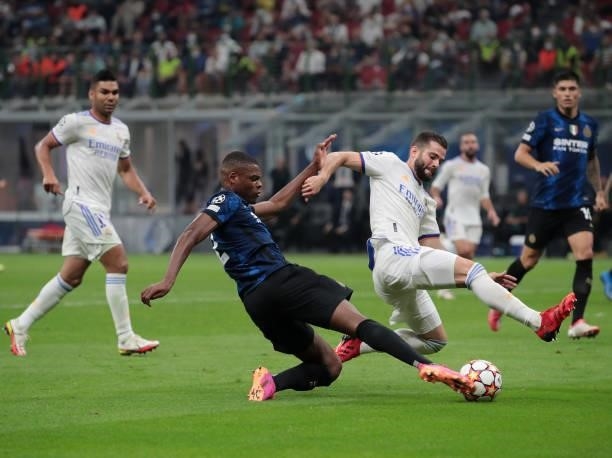 Denzel Dumfries of FC Internazionale is challenged by Nacho Fernández of Real Madrid during the UEFA Champions League group D match between Inter and...