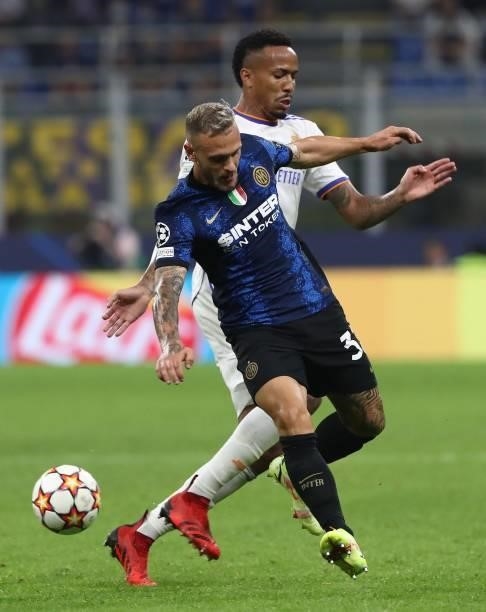 Federico Dimarco of FC Internazionale competes for the ball with Eder Militao of Real Madrid during the UEFA Champions League group D match between...