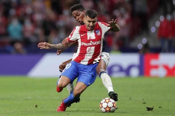Angel Correa of Atletico Madrid is tackled by Wendell of FC Porto during the UEFA Champions League group B match between Atletico Madrid and FC Porto...