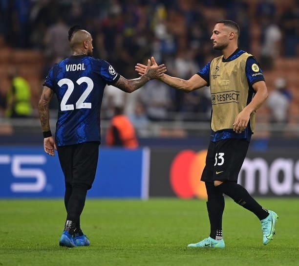Arturo Vidal of FC Internazionale shakes hand with Danilo D'Ambrosio at the end of the UEFA Champions League group D match between Inter and Real...