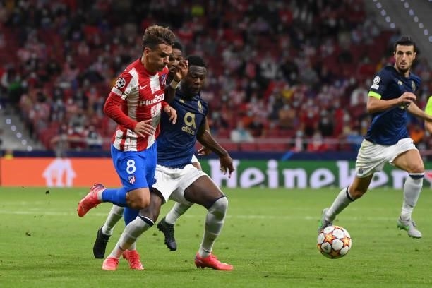 Chancel Mbemba of FC Porto commits a foul on Antoine Griezmann of Atletico Madrid and is later shown a red card during the UEFA Champions League...