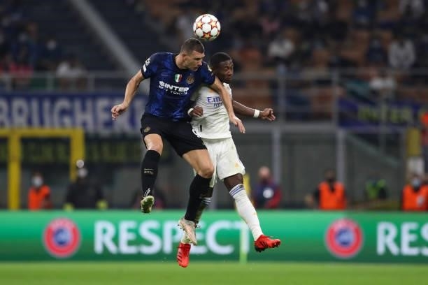 Edin Dzeko of FC Internazionale challenges for an aerial ball with David Alaba of Real Madrid during the UEFA Champions League group D match between...