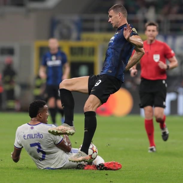 Edin Dzeko of FC Internazionale is challenged by Eder Militao of Real Madrid CF during the UEFA Champions League group D match between FC...