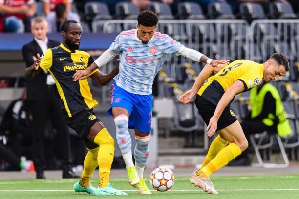 Jadon Sancho of Manchester United plays against Vincent Sierro and Nicolas Moumi of Young Boys during the UEFA Champions League group F match between...