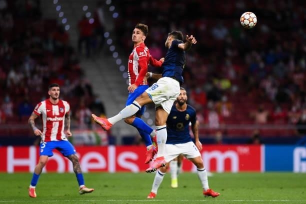 Antoine Griezmann of Atletico de Madrid competes for the ball with Marko Grujić of FC Porto during the UEFA Champions League group B match between...