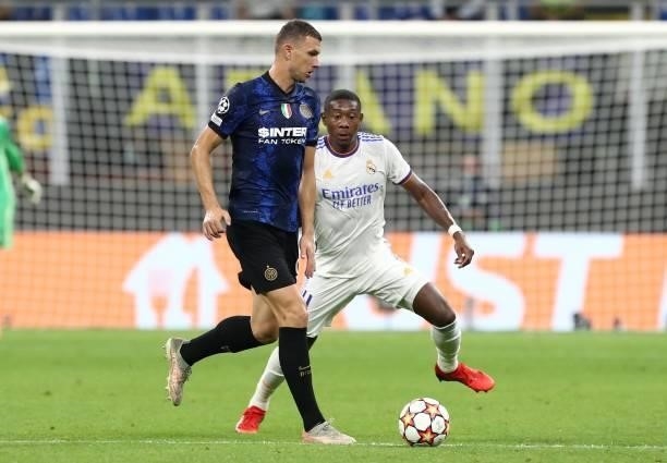 Edin Dzeko of FC Internazionale is challenged by David Alaba of Real Madrid during the UEFA Champions League group D match between Inter and Real...