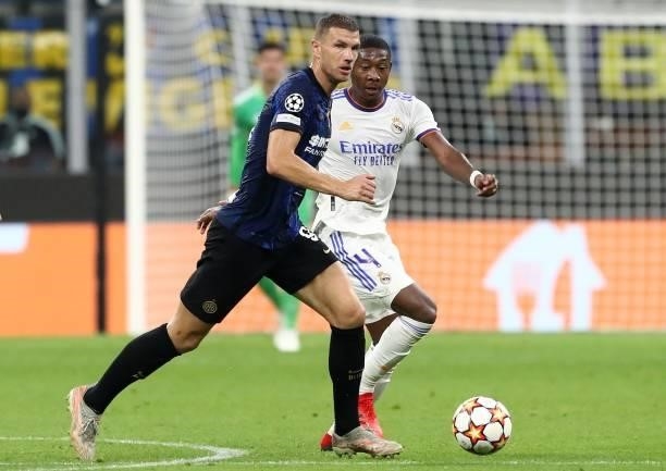 Edin Dzeko of FC Internazionale is challenged by David Alaba of Real Madrid during the UEFA Champions League group D match between Inter and Real...
