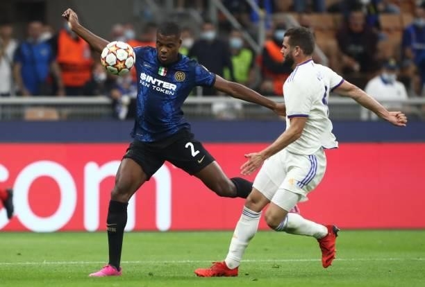 Denzel Dumfries of FC Internazionale competes for the ball with Nacho of Real Madrid during the UEFA Champions League group D match between Inter and...