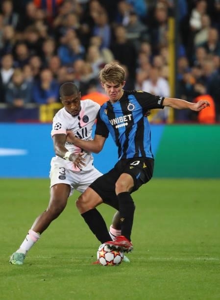 Charles De Ketelaere of Club Brugge battles for the ball with Presnel Kimpembe of PSG during the UEFA Champions League group A match between Club...