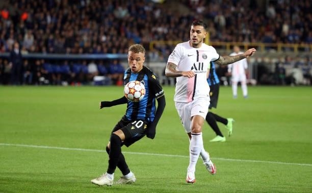 Noa Lang of Club Brugge battles for the ball with Leandro Paredes of PSG during the UEFA Champions League group A match between Club Brugge KV and...