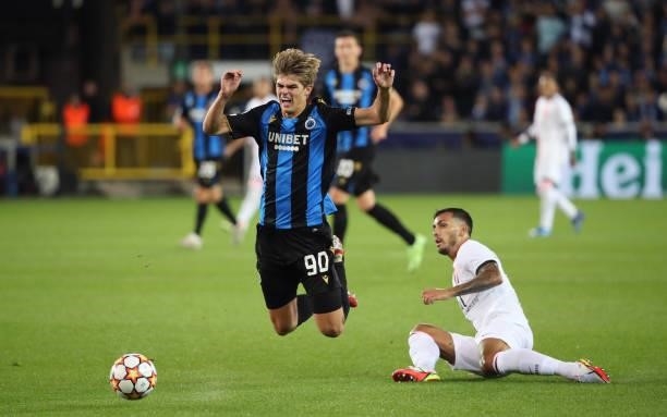 Charles De Ketelaere of Club Brugge battles for the ball with Leandro Paredes of PSG during the UEFA Champions League group A match between Club...