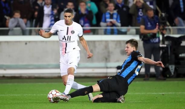 Achraf Hakimi Mouh of PSG battles for the ball with Eduard Sobol of Club Brugge during the UEFA Champions League group A match between Club Brugge KV...