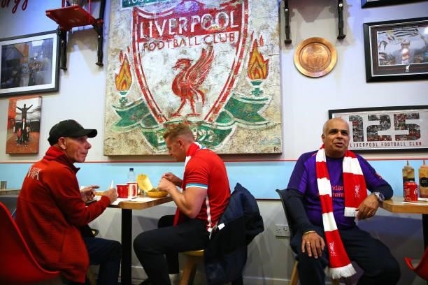 Supporters of Liverpool eat at the Georgie Porgy Cafe prior to the UEFA Champions League group B match between Liverpool FC and AC Milan at Anfield...