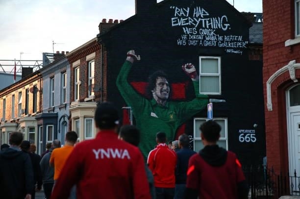 Liverpool supporters pass a mural of Ray Clemence outside Anfield prior to the UEFA Champions League group B match between Liverpool FC and AC Milan...