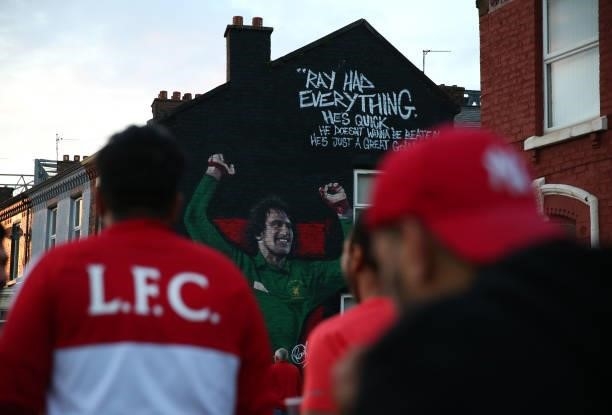 Liverpool supporters pass a mural of Ray Clemence outside Anfield prior to the UEFA Champions League group B match between Liverpool FC and AC Milan...