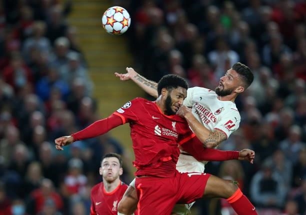 Joe Gomez of Liverpool FC battles for the ball with Olivier Giroud of AC Milan during the UEFA Champions League group B match between Liverpool FC...