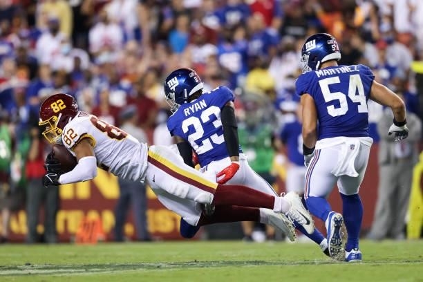 Logan Thomas of the Washington Football Team dives ahead of Logan Ryan of the New York Giants during the second quarter at FedExField on September...