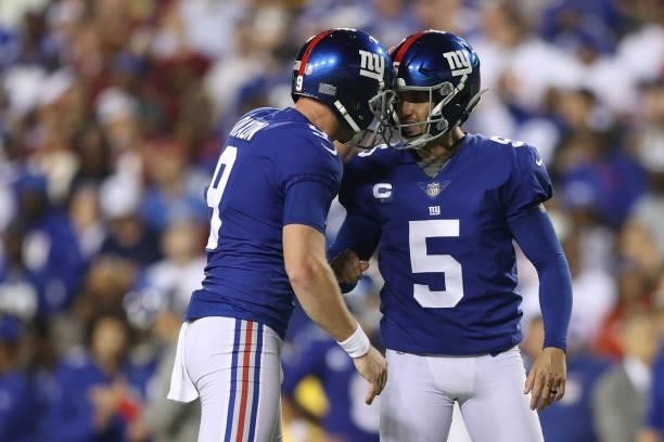 Graham Gano of the New York Giants reacts with Riley Dixon after kicking a 23 yard field goal during the second quarter against the Washington...