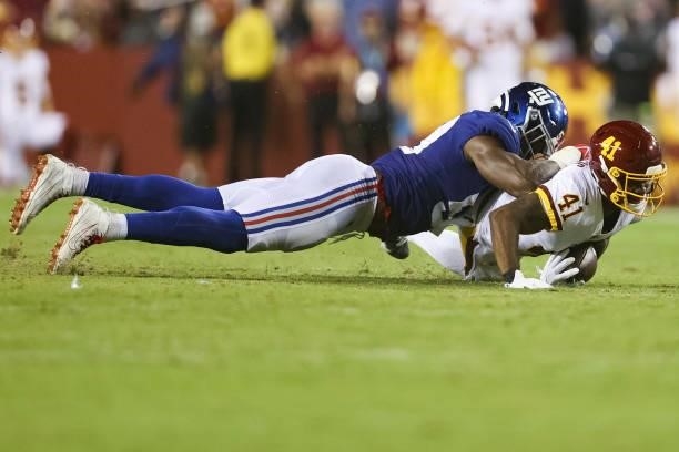 Lorenzo Carter of the New York Giants tackles J.D. McKissic of the Washington Football Team during the second quarter at FedExField on September 16,...