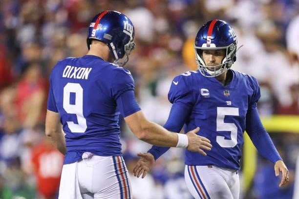 Riley Dixon of the New York Giants and Graham Gano celebrate a field goal during the third quarter against the Washington Football Team at FedExField...