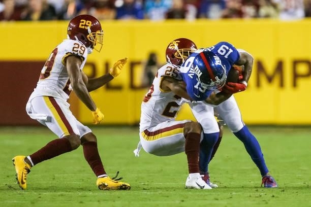 Kenny Golladay of the New York Giants is brought down by Benjamin St-Juste of the Washington Football Team during the third quarter at FedExField on...