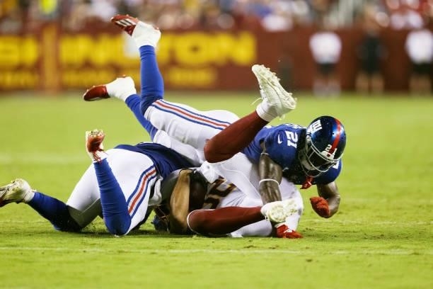 Jabrill Peppers of the New York Giants brings down Logan Thomas of the Washington Football Team during the third quarter at FedExField on September...