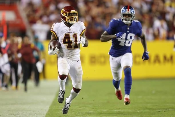 McKissic of the Washington Football Team rushes ahead of Tae Crowder of the New York Giants during the fourth quarter at FedExField on September 16,...