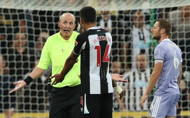 Referee Mike Dean interacts with Isaac Hayden of Newcastle United during the Premier League match between Newcastle United and Leeds United at St....