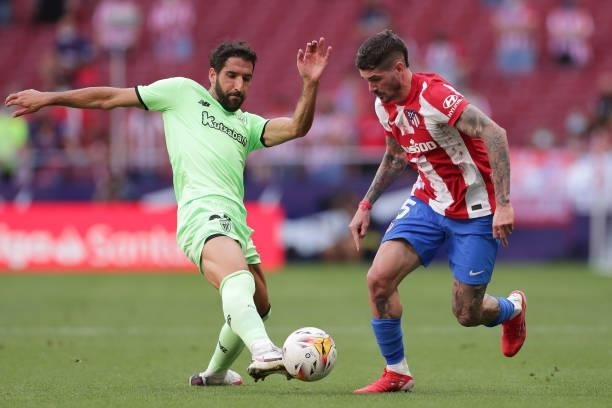 Raul Garcia of Athletic Club competes for the ball with Rodrigo de Paul of Atletico de Madrid during the La Liga Santander match between Club...