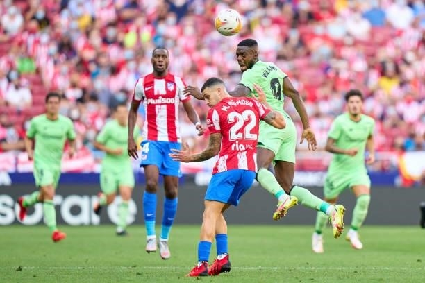 Mario Hermoso of Atletico de Madrid battles for the ball with Inaki Williams of Athletic Club during the La Liga Santander match between Club...