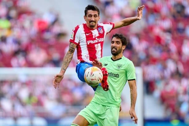 Stefan Savic of Atletico de Madrid battles for the ball with Raul Garcia of Athletic Club during the La Liga Santander match between Club Atletico de...