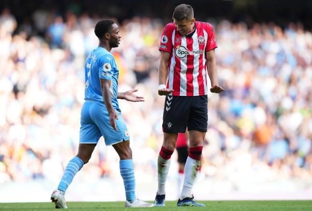 Raheem Sterling of Manchester City and Jan Bednarek of Southampton react during the Premier League match between Manchester City and Southampton at...