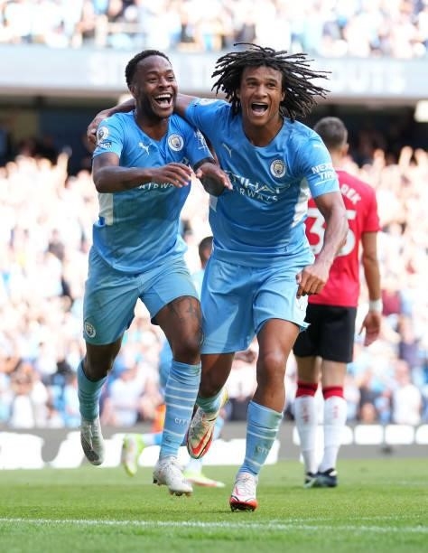 Raheem Sterling of Manchester City celebrates with teammate Nathan Ake after scoring a goal which is later disallowed due to offside during the...