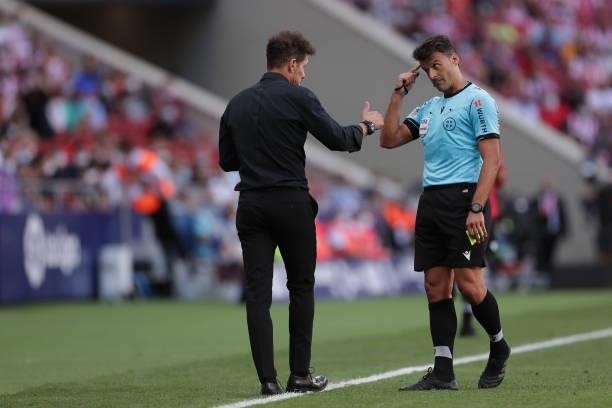 Referee Gil Manzano argues with manager Diego Simeone of Atletico de Madrid during the La Liga Santander match between Club Atletico de Madrid and...