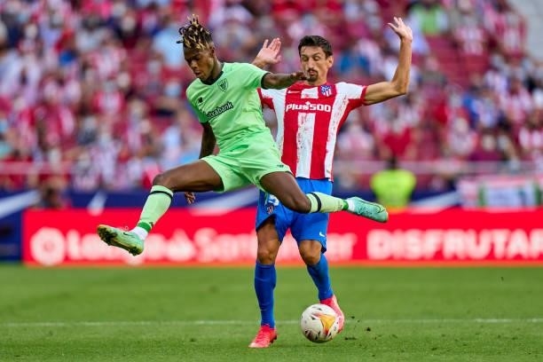 Stefan Savic of Atletico de Madrid battles for the ball with Nico Williams of Athletic Club during the La Liga Santander match between Club Atletico...