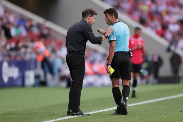 Referee Gil Manzano argues with manager Diego Simeone of Atletico de Madrid during the La Liga Santander match between Club Atletico de Madrid and...