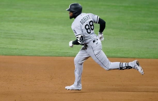 Luis Robert of the Chicago White Sox runs to second base after hitting a three run double against the Texas Rangers during the fourth inning at Globe...