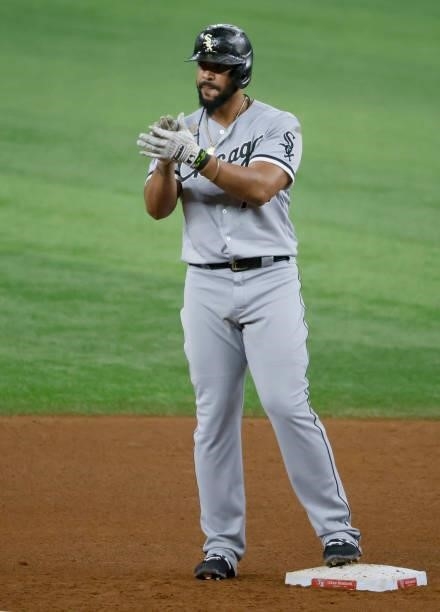 Jose Abreu of the Chicago White Sox reacts after hitting a run double against the Texas Rangers during the fourth inning at Globe Life Field on...