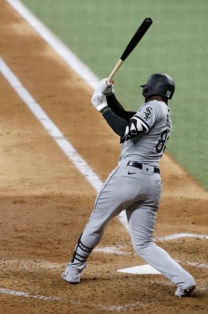 Luis Robert of the Chicago White Sox hits a three run double against the Texas Rangers during the fourth inning at Globe Life Field on September 17,...