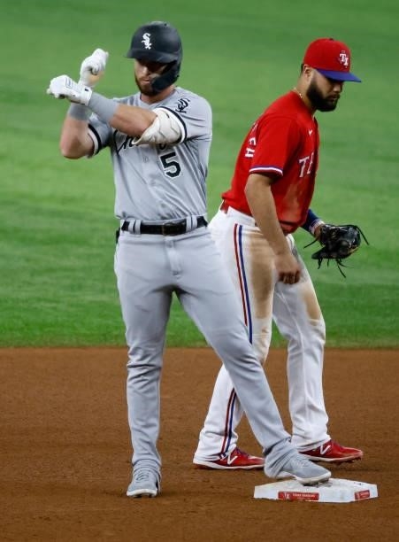 Romy Gonzalez of the Chicago White Sox reacts after hitting a double as Isiah Kiner-Falefa of the Texas Rangers looks on during the fourth inning at...