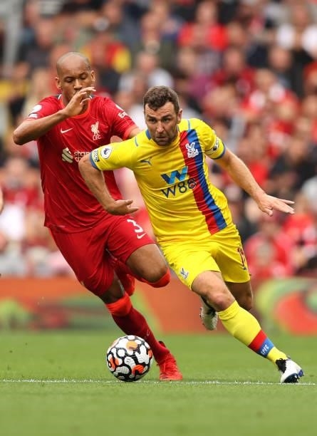 James McArthur of Crystal Palace is chased by Fabinho of Liverpool clash during the Premier League match between Liverpool and Crystal Palace at...