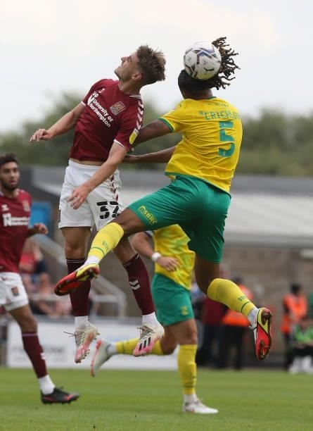 Danny Rose of Northampton Town challenges for the ball with Romoney Chrichlow of Swindon Town during the Sky Bet League Two match between Northampton...