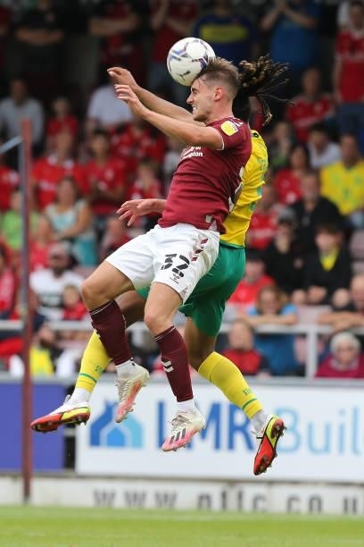 Danny Rose of Northampton Town challenges for the ball with Romoney Chrichlow of Swindon Town during the Sky Bet League Two match between Northampton...