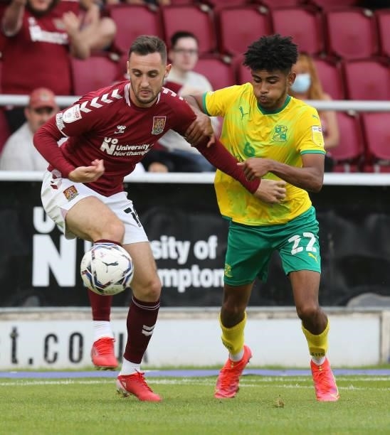 Dylan Connolly of Northampton Town contests the ball with Kaine Kesler-Hayden of Swindon Town during the Sky Bet League Two match between Northampton...