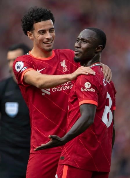 Naby Keïta of Liverpool is congratulated by team mate Curtis Jones after scoring the third goal during the Premier League match between Liverpool and...