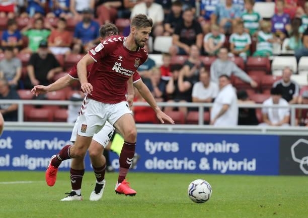Jon Guthrie of Northampton Town moves forward with the ball during the Sky Bet League Two match between Northampton Town and Swindon Town at...