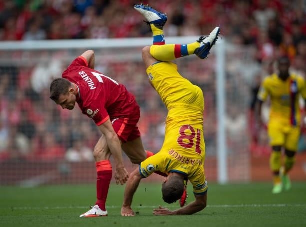 James McArthur of Crystal Palace in action with James Milner of Liverpool during the Premier League match between Liverpool and Crystal Palace at...
