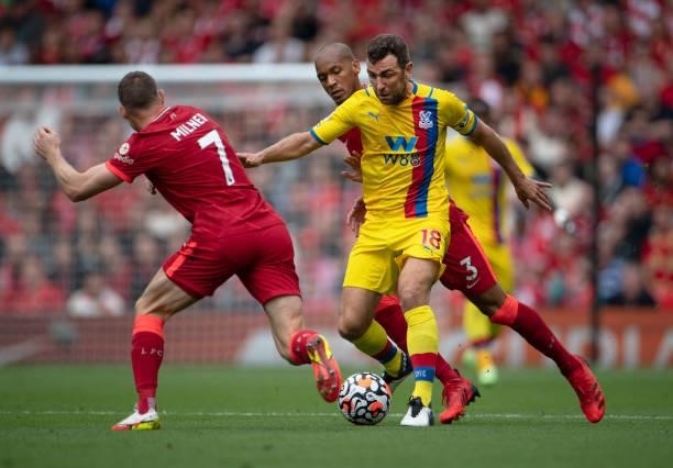 James McArthur of Crystal Palace in action with James Milner and Fabinho of Liverpool during the Premier League match between Liverpool and Crystal...